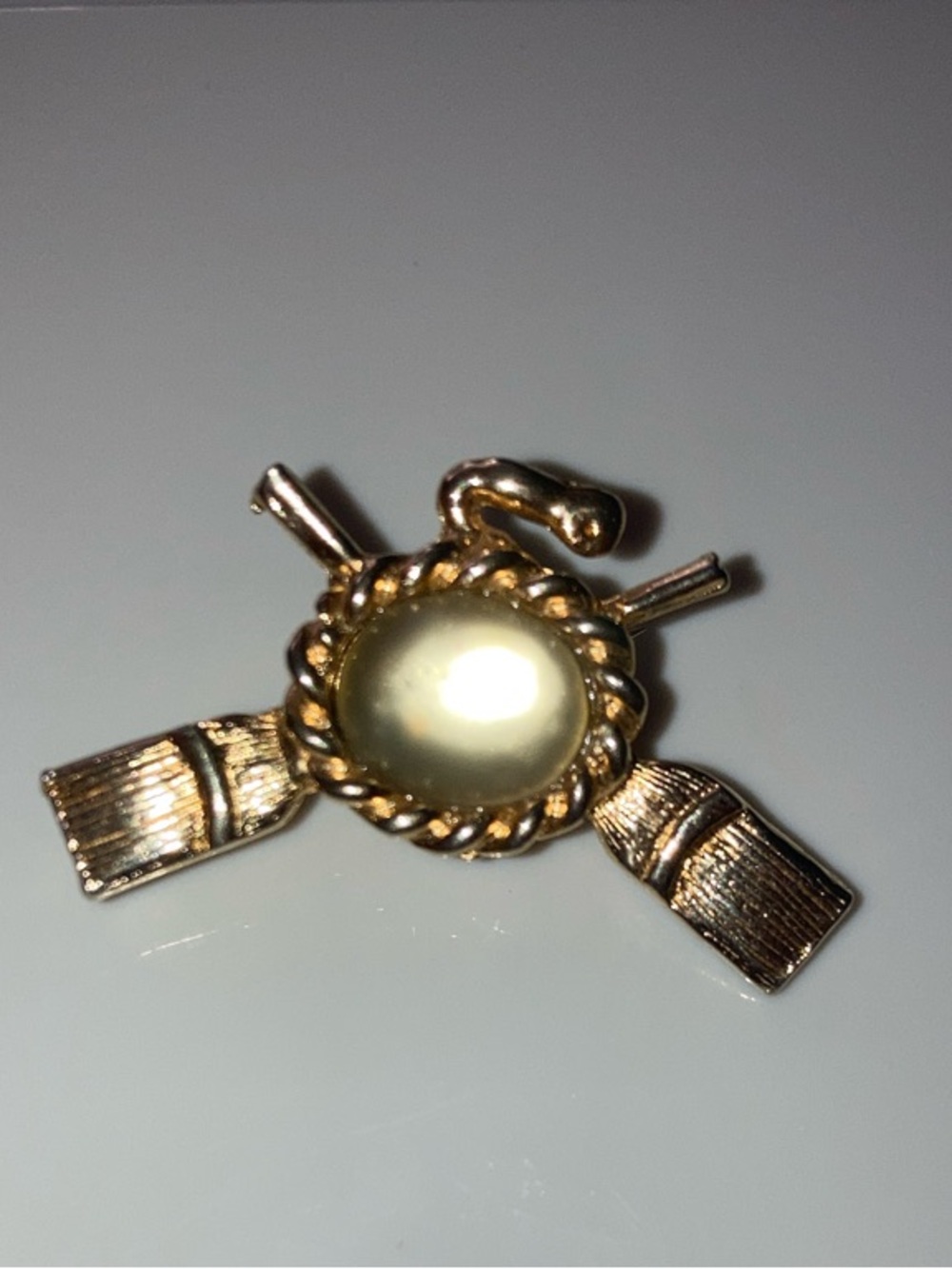 Curling Rock Gold-Tone Rope Frame Brooch with Champagne Cabochon